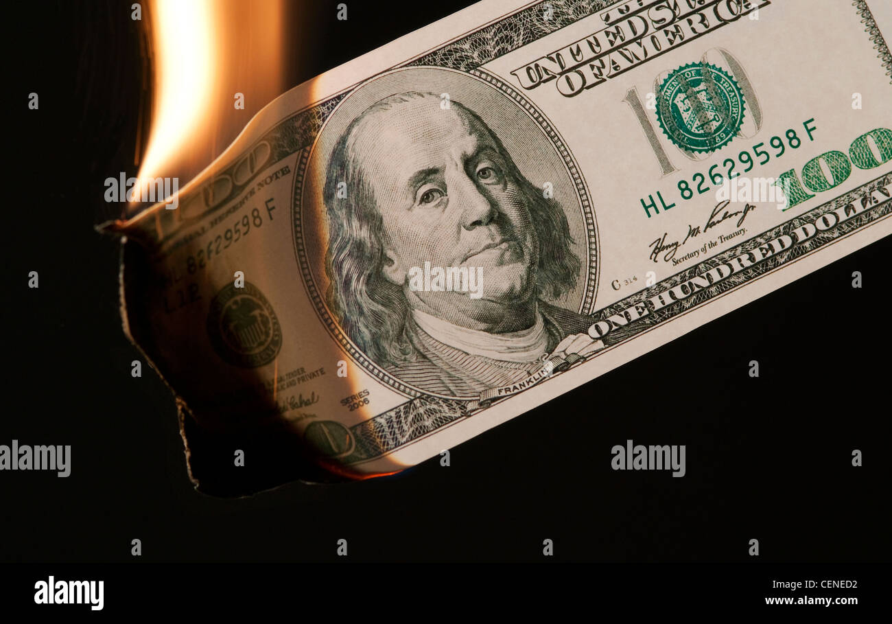burning money US 100 dollar bill on black background Stock Photo - Alamy