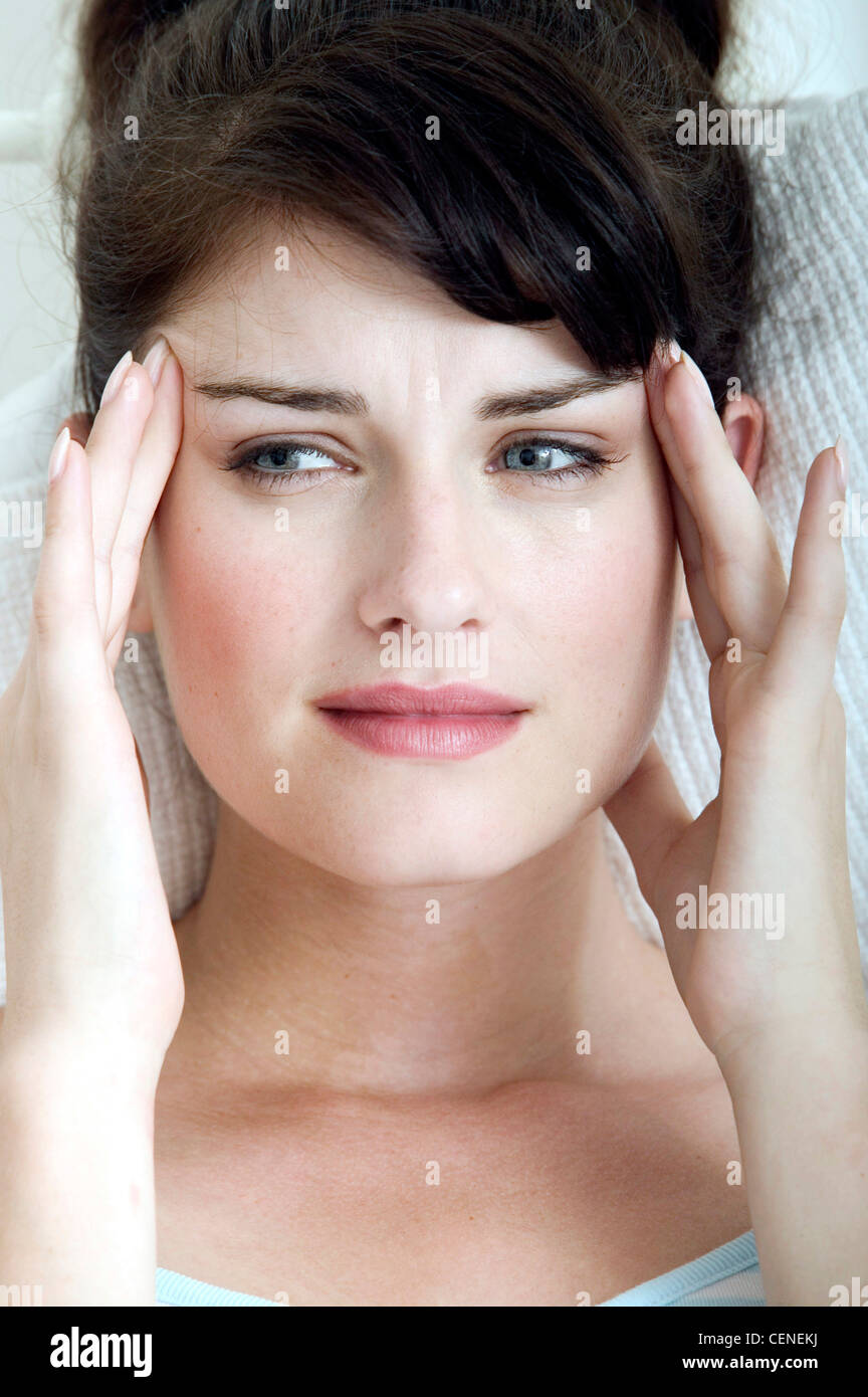 Female with hair off face, looking to side unsmiling with both