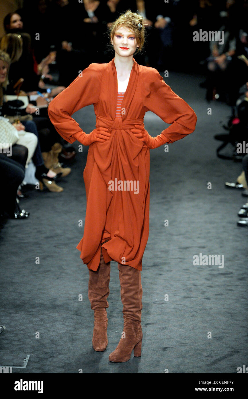 Sonia Rykiel Paris Ready to Wear Autumn Winter Gathered orange dress and  matching gloves, with brown knee length suede boots Stock Photo - Alamy