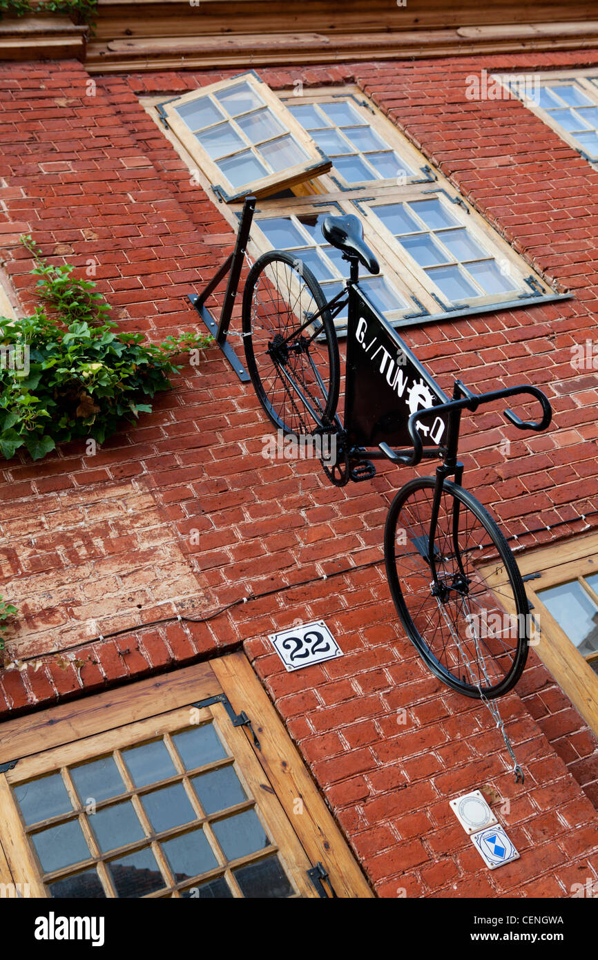Bicycle hanged at a house wall in Dutch District, Potsdam, Brandenburg, Germany Stock Photo