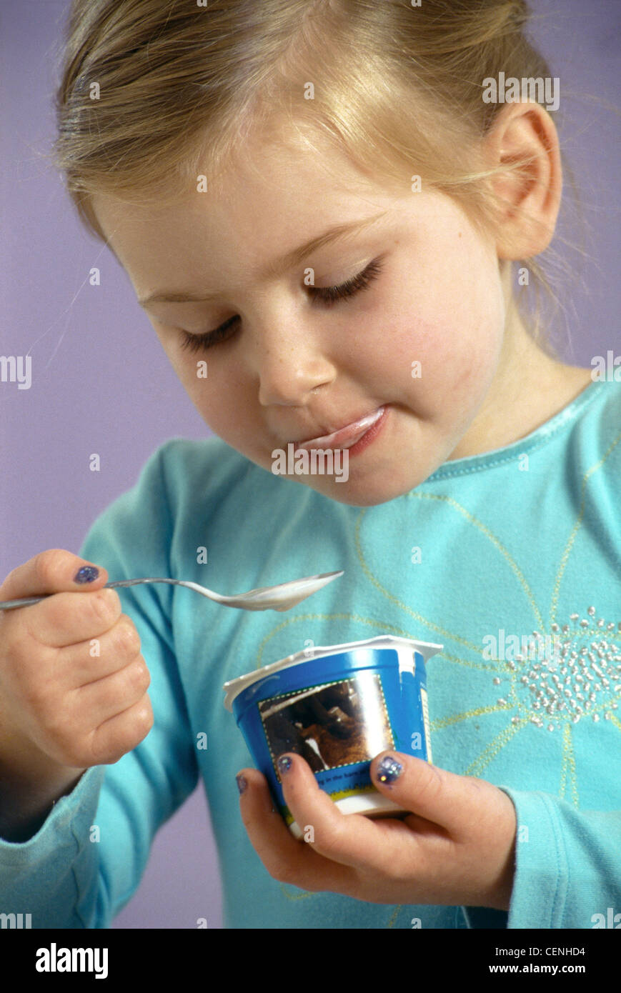 a Female child blonde hair off face wearing blue top yellow flower