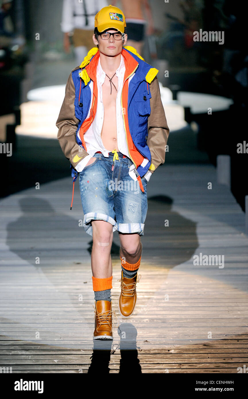 DSquared Milan Ready to Wear Spring Summer Bespectacles male wearing  brightly coloured baseball cap, zipper jacket, white Stock Photo - Alamy