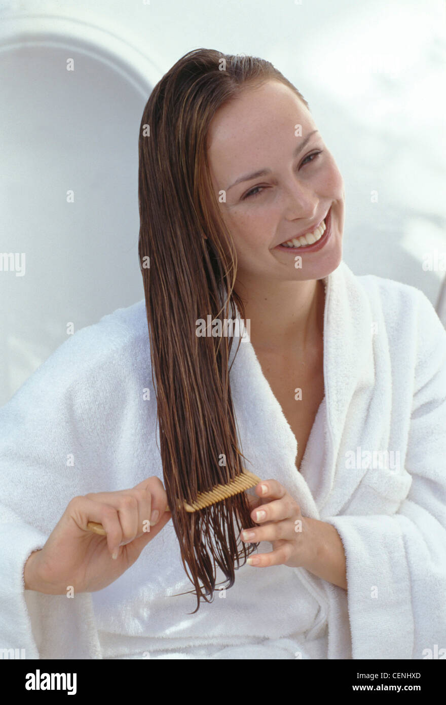 Female Long Wet Dark Blonde Hair Wearing White Towelling Dressing Gown Sitting Brushing Hair Comb Looking To Camera Smiling Stock Photo Alamy