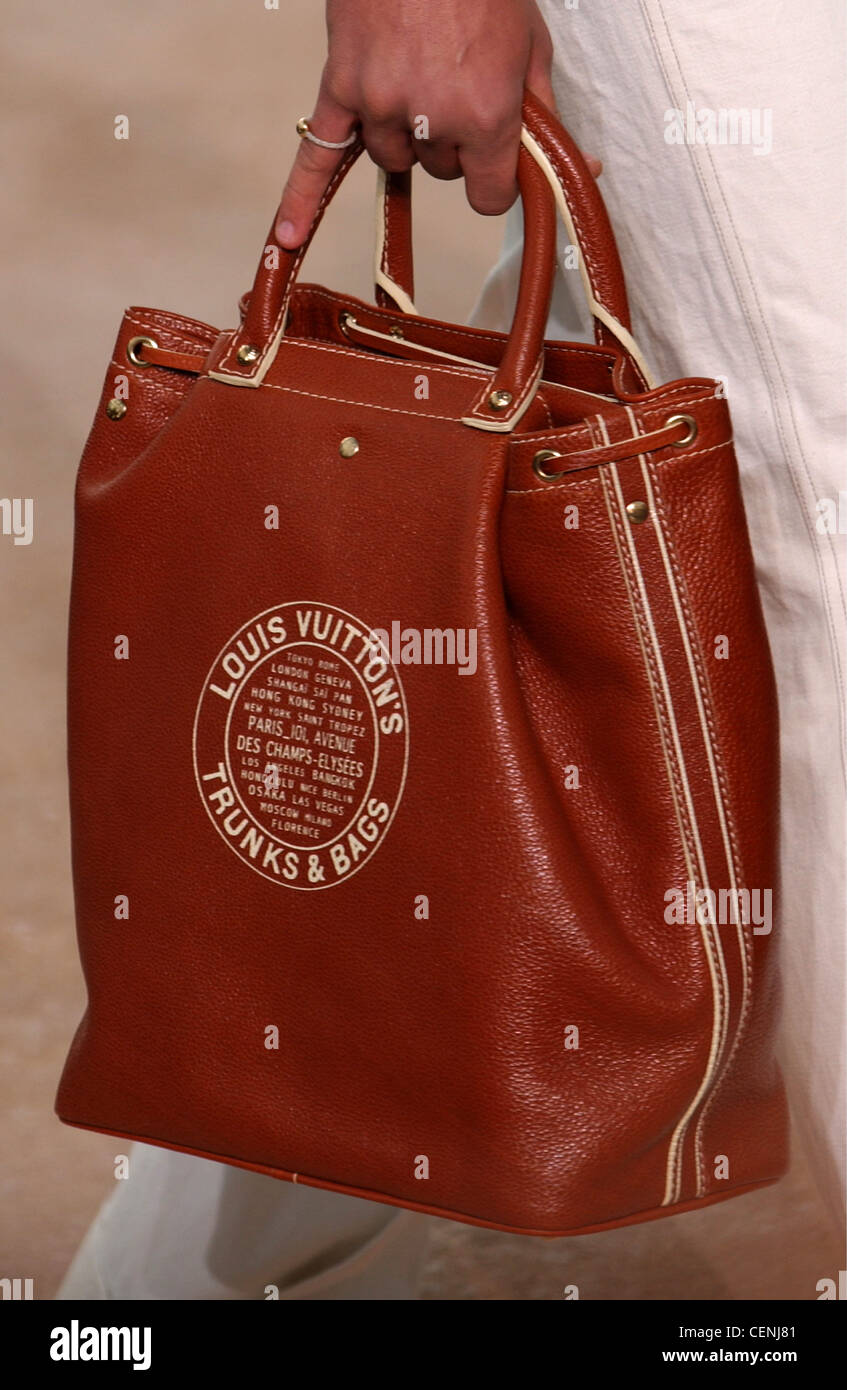 Louis Vuitton Paris Menswear S S Cropped hand holding brown leather bag  with short handles Stock Photo - Alamy