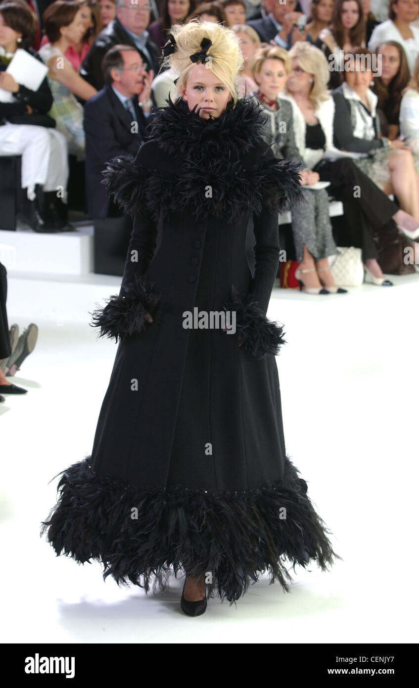 Chanel Paris, Haute Couture A W Long black frock coat with feather trim,  black shoes and black bows in hair Stock Photo - Alamy