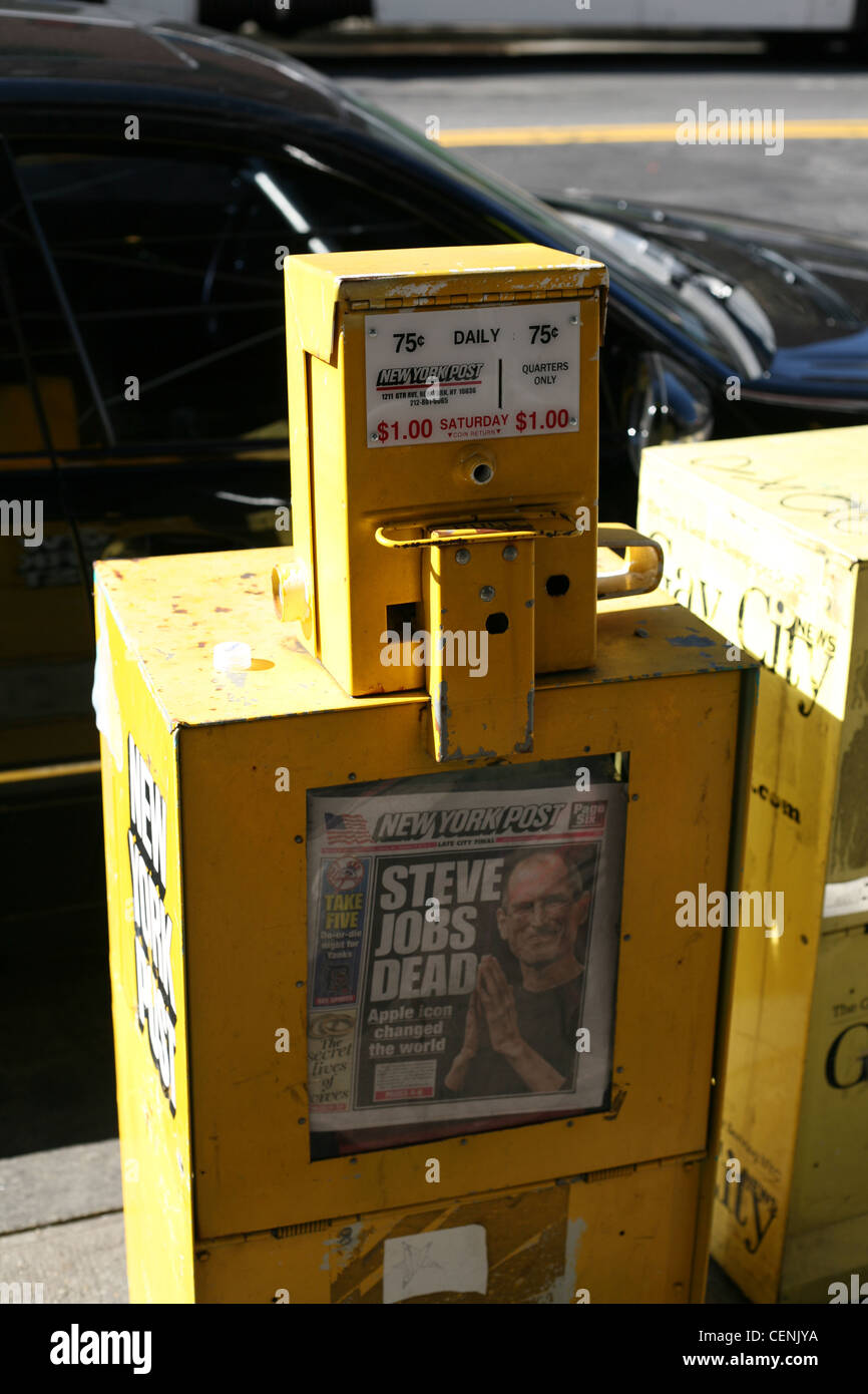 Newspaper vending machine with the New York Post showing the headline Steve Jobs Dead Stock