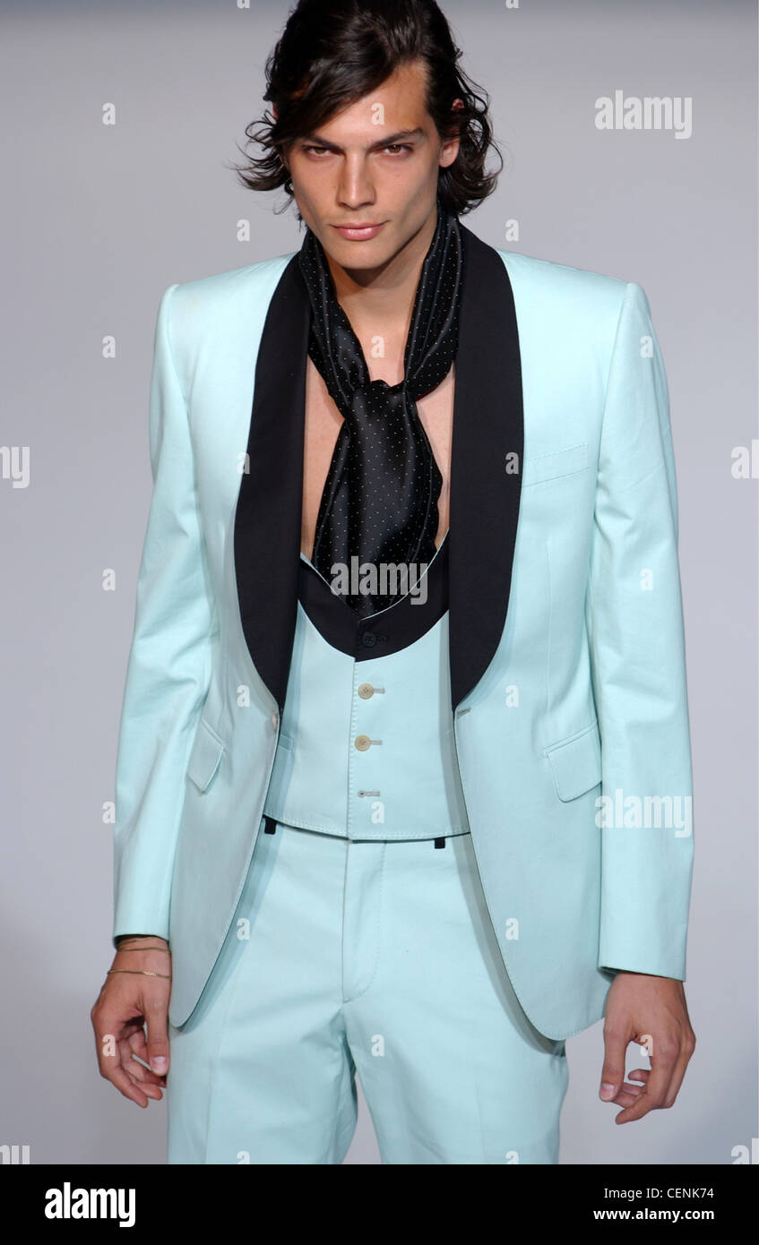 Givenchy Paris Menswear S S Male model wearing black and blue three piece suit with black spotted neckscarf Stock Photo