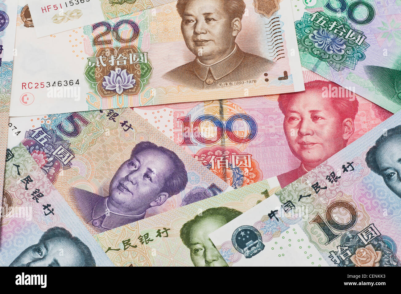 Many Yuan bills with the portrait of Mao Zedong lying side by side. The renminbi, the Chinese currency, was introduced in 1949 Stock Photo