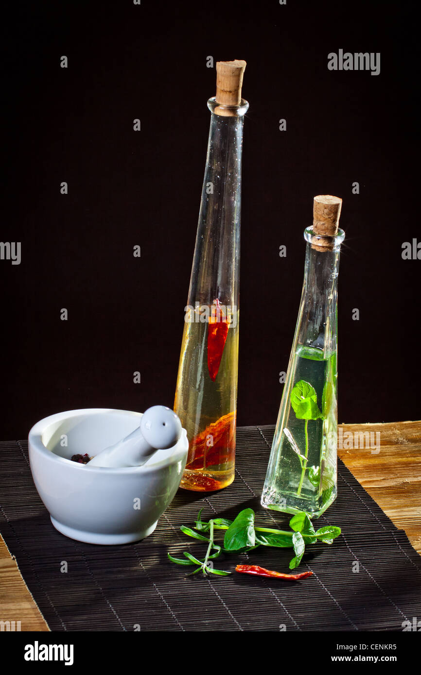 Mortar and pestle next to olive oil bottles Stock Photo Alamy