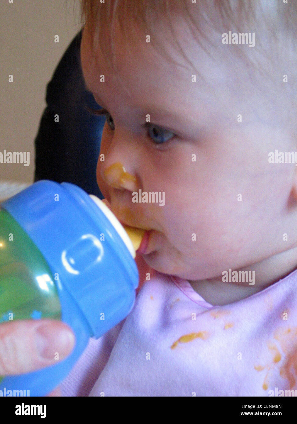 Baby drinking from a plastic feeding bottle Stock Photo Alamy