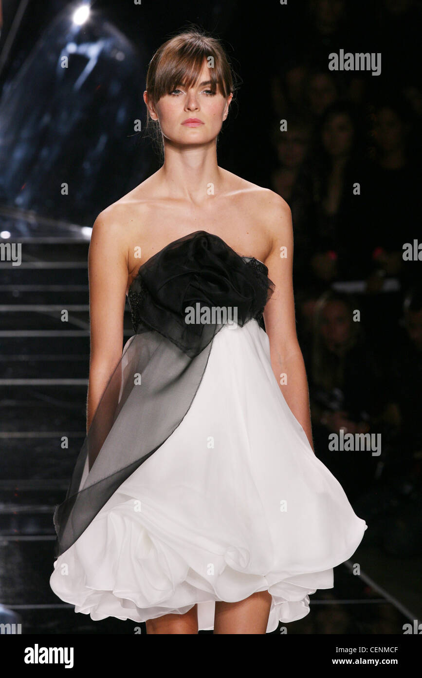 Brunette female model Anouck Lepere wearing a short black and white ...