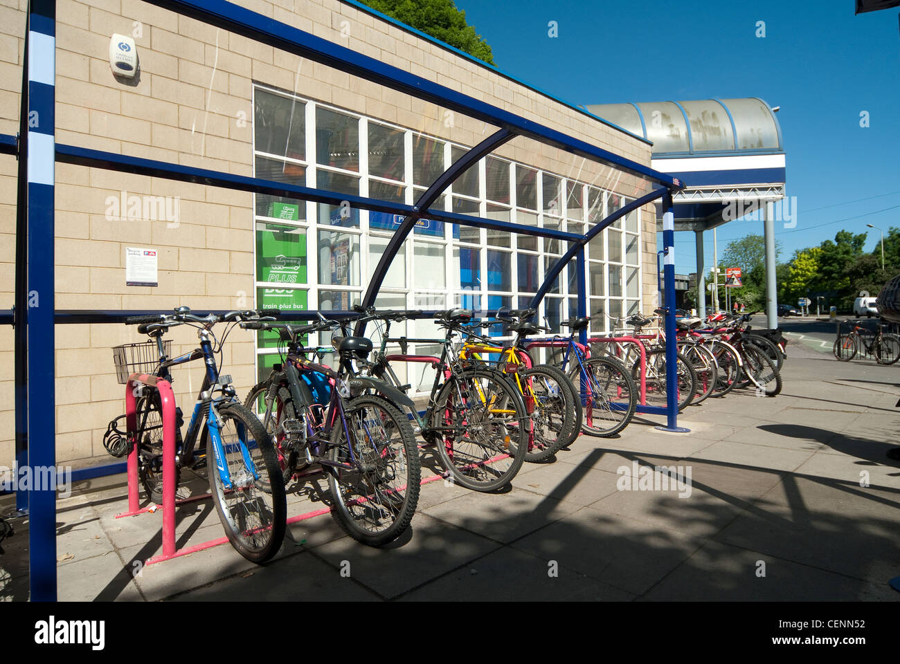 Bicycles securely parked in a bicycle shed outside a railway station in England. Stock Photo