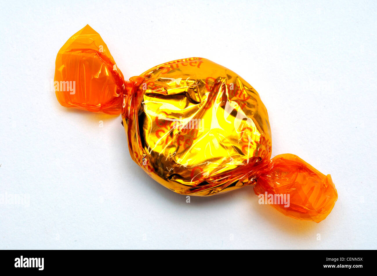 A single Quality Street chocolate wrapped in orange foil Stock Photo