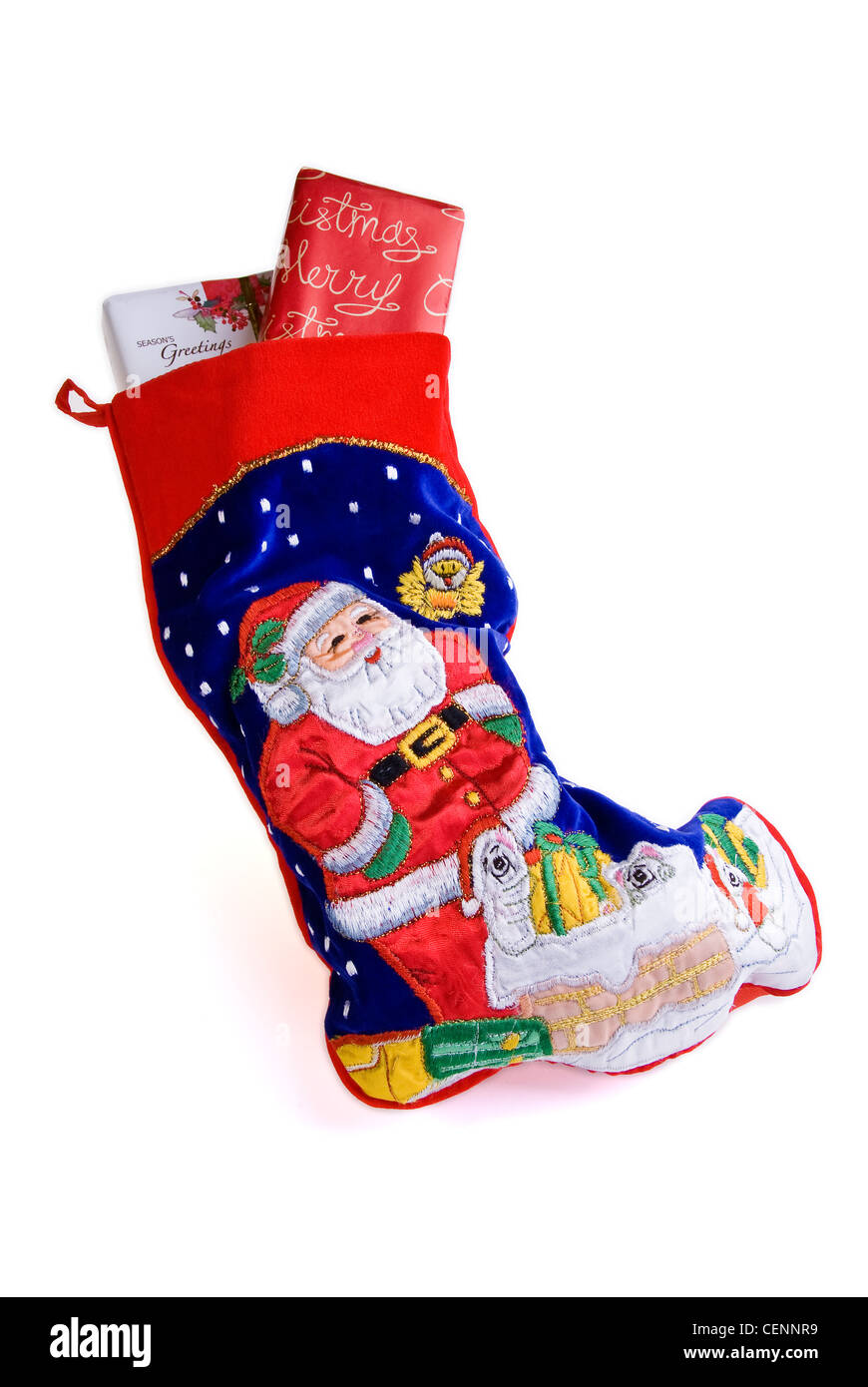 Traditional Christmas stocking with wrapped gifts. Stock Photo