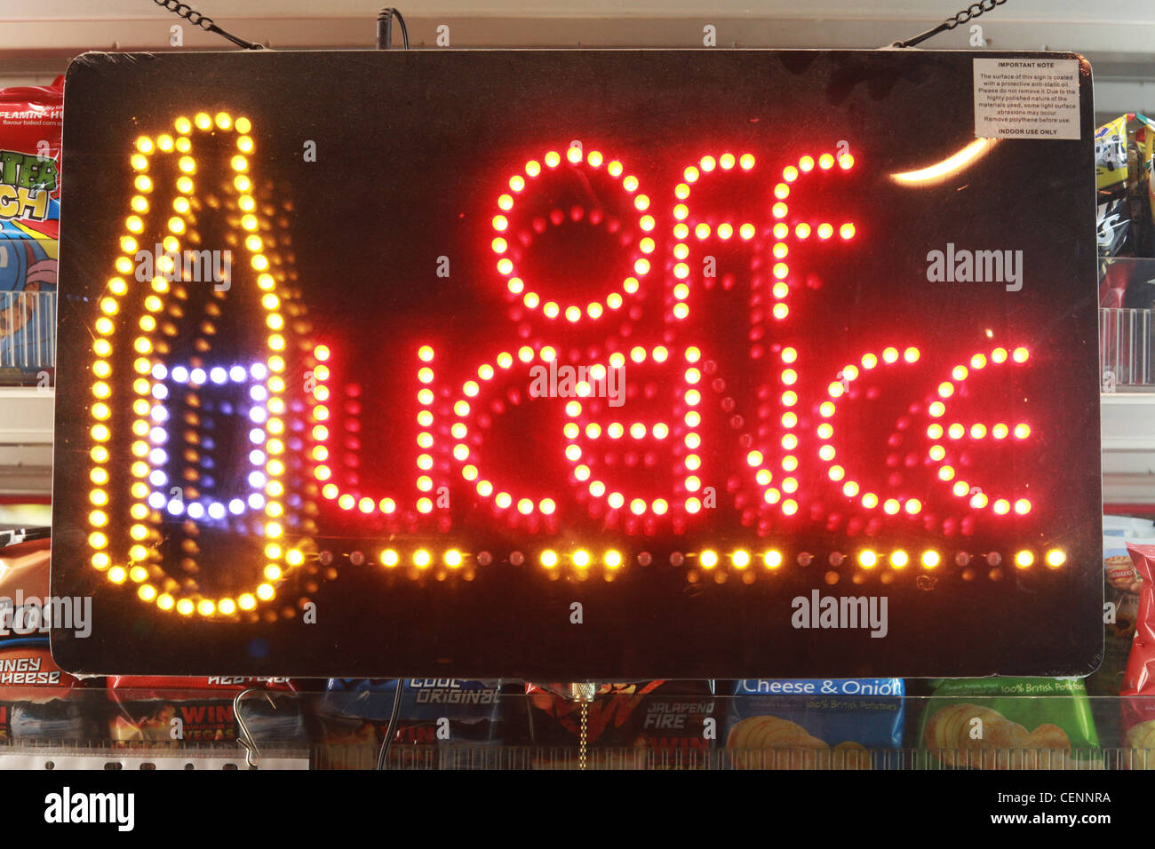 Neon Off Licence sign in a newsagents shop window advertising alcohol