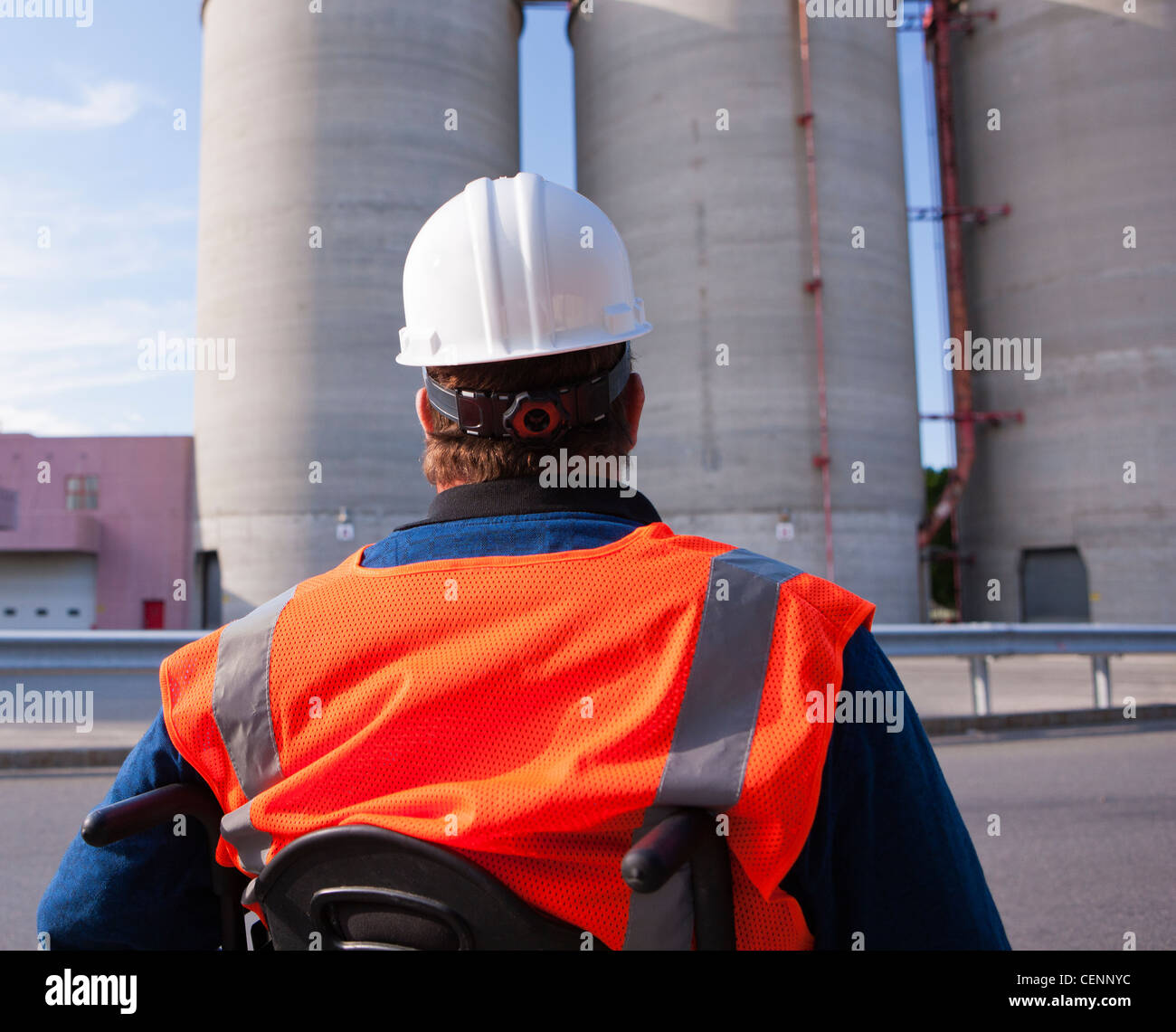 Facilities engineer in a wheelchair inspecting outdoor bulk storage