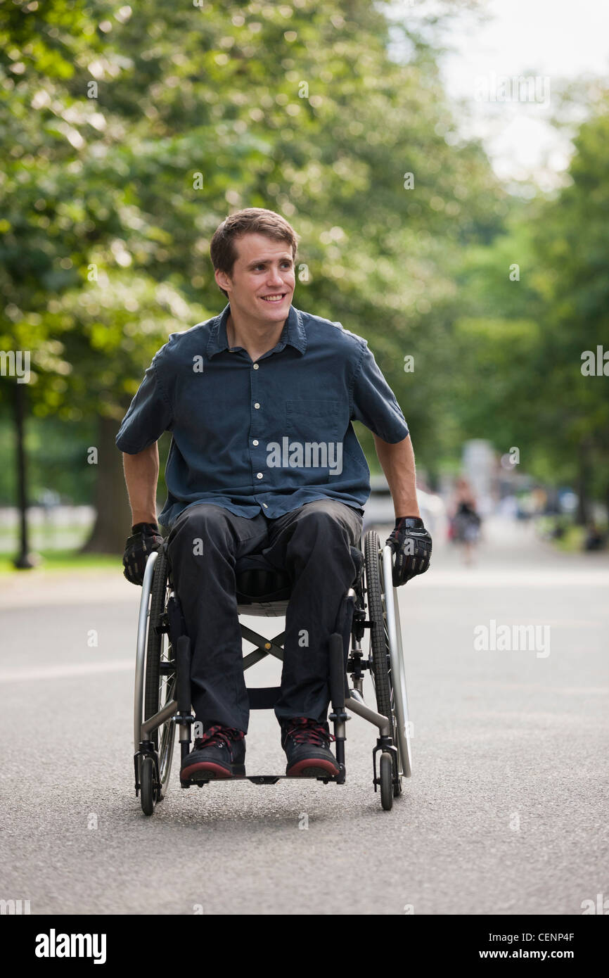 Man with spinal cord injury in a wheelchair maneuvering wheelchair on