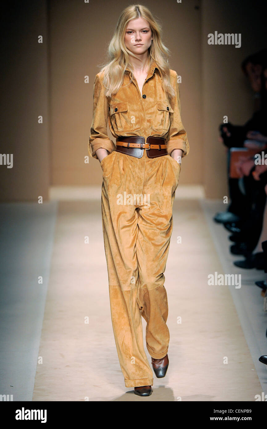 Salvatore Ferragamo Milan Ready to Wear Autumn Winter Mustard colour suede  jumpsuit, with wide brown leather belt Stock Photo - Alamy