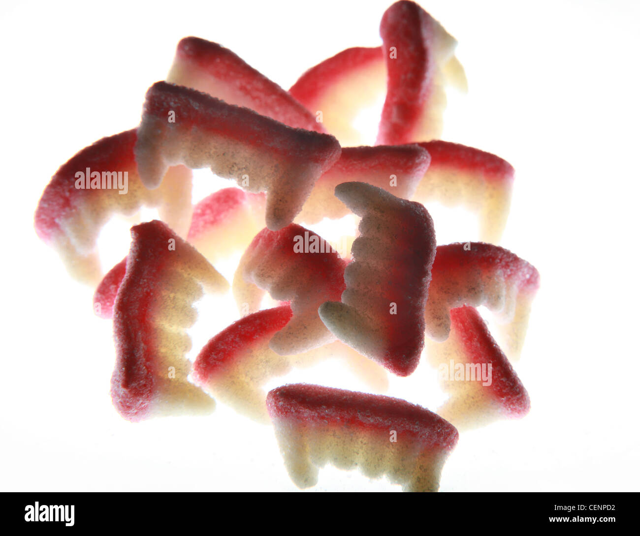16 sets of candy, sweet, sugar vampire teeth in a pile. Stock Photo