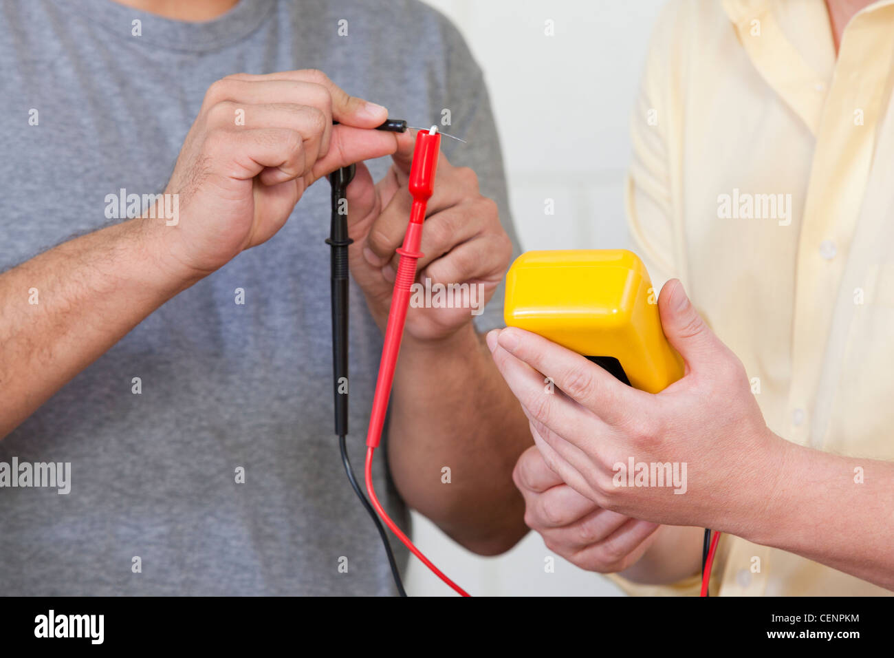 Engineering students measuring resistor using multimeter Stock Photo