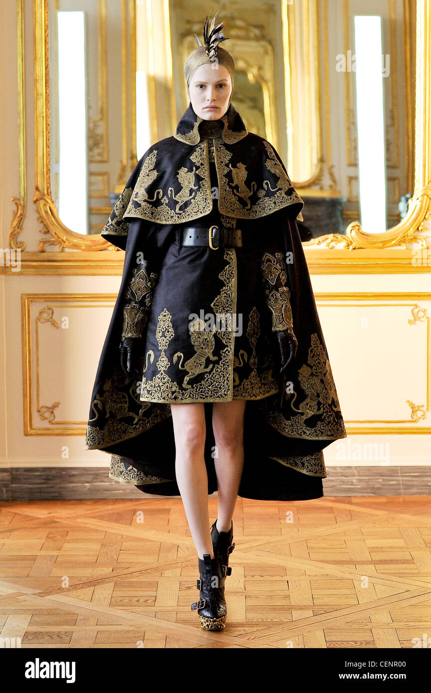 Alexander McQueen Paris Ready to Wear Autumn Winter Final Show Black cape  coat gold embroidery and black belt, black gloves Stock Photo - Alamy