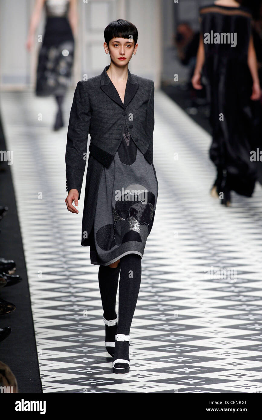 Antonio Marras Milan Fashion Week Autumn Winter Model wearing grey jersey dress applique circles pattern in black and silver Stock Photo