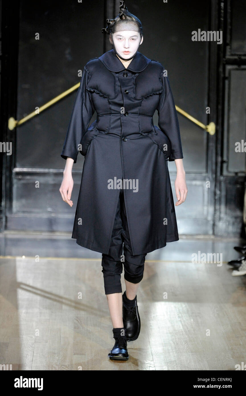 Comme des Garcons Paris Ready to Wear Autumn Winter Black puffer coat,  black cropped trousers, black net over head, black socks Stock Photo - Alamy