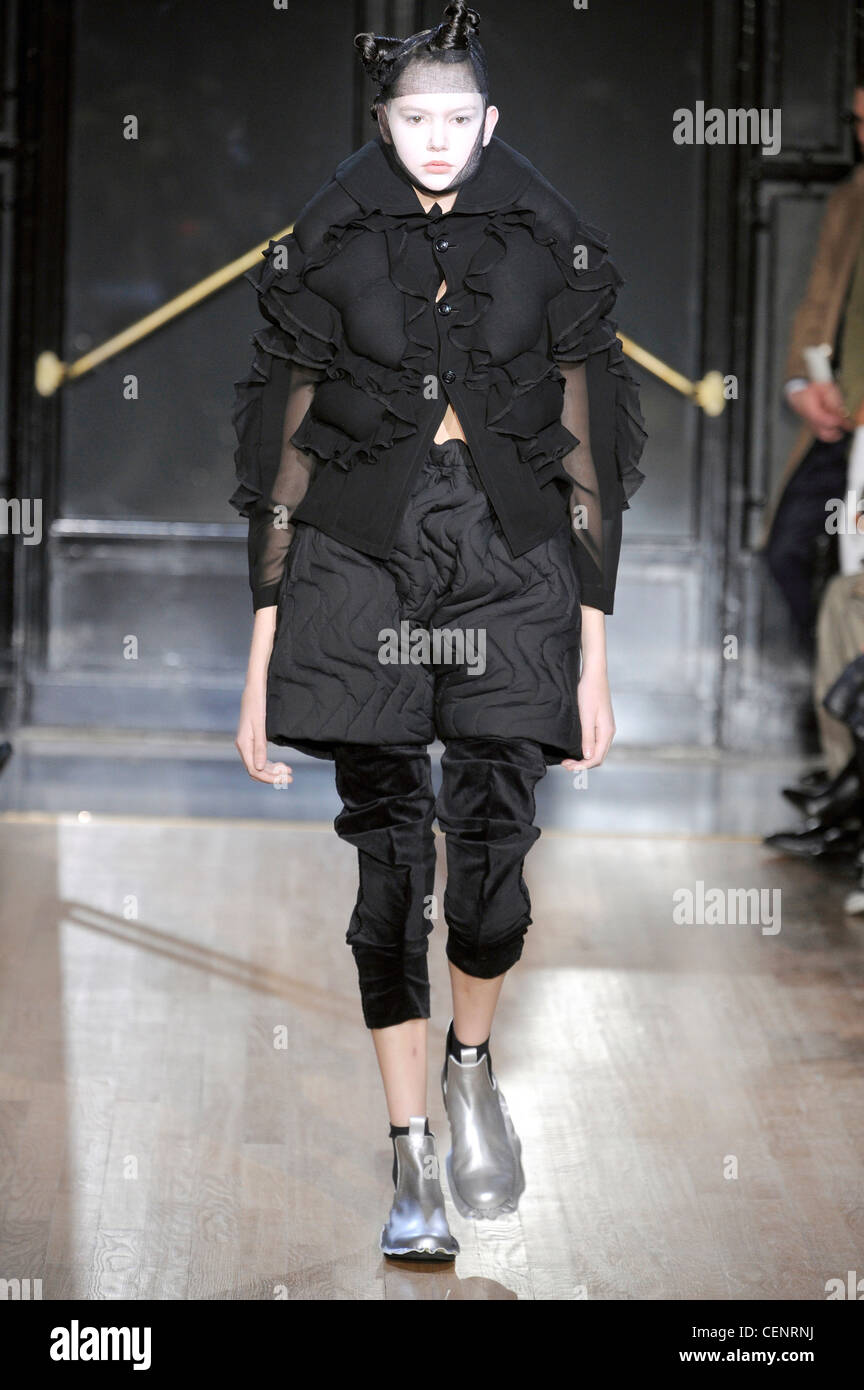 Comme des Garcons Paris Ready to Wear Autumn Winter Black frilled puffer  jacket, textured black shorts, black cropped trousers Stock Photo - Alamy