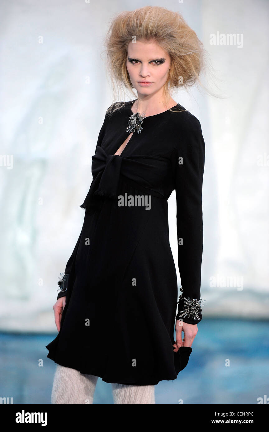 Chanel Paris Ready to Wear Autumn Winter Short empire line b lack dress  with brooch and matching embellishments on cuffs Stock Photo - Alamy