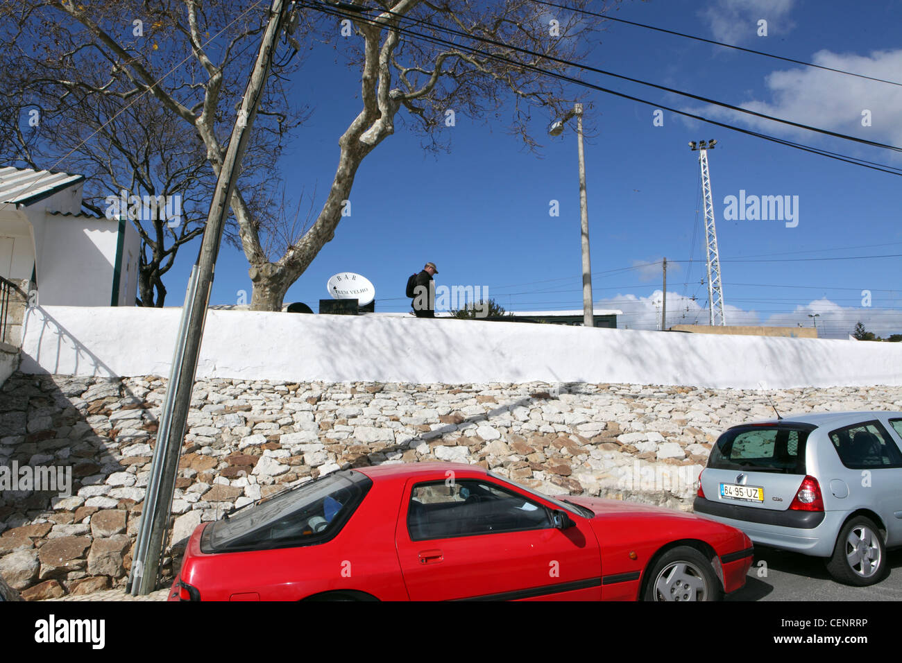 red sports coupe blue sky Lisbon Portugal tree Stock Photo