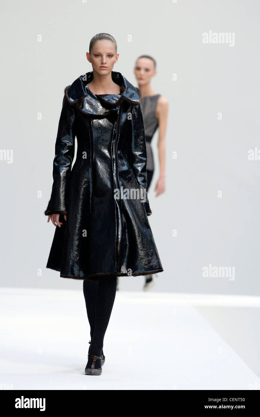 Alberta Ferretti Milan Fashion Week Autumn Winter Model Michaela Kocianova wearing black shiny textured patent leather coat, Stock Photo
