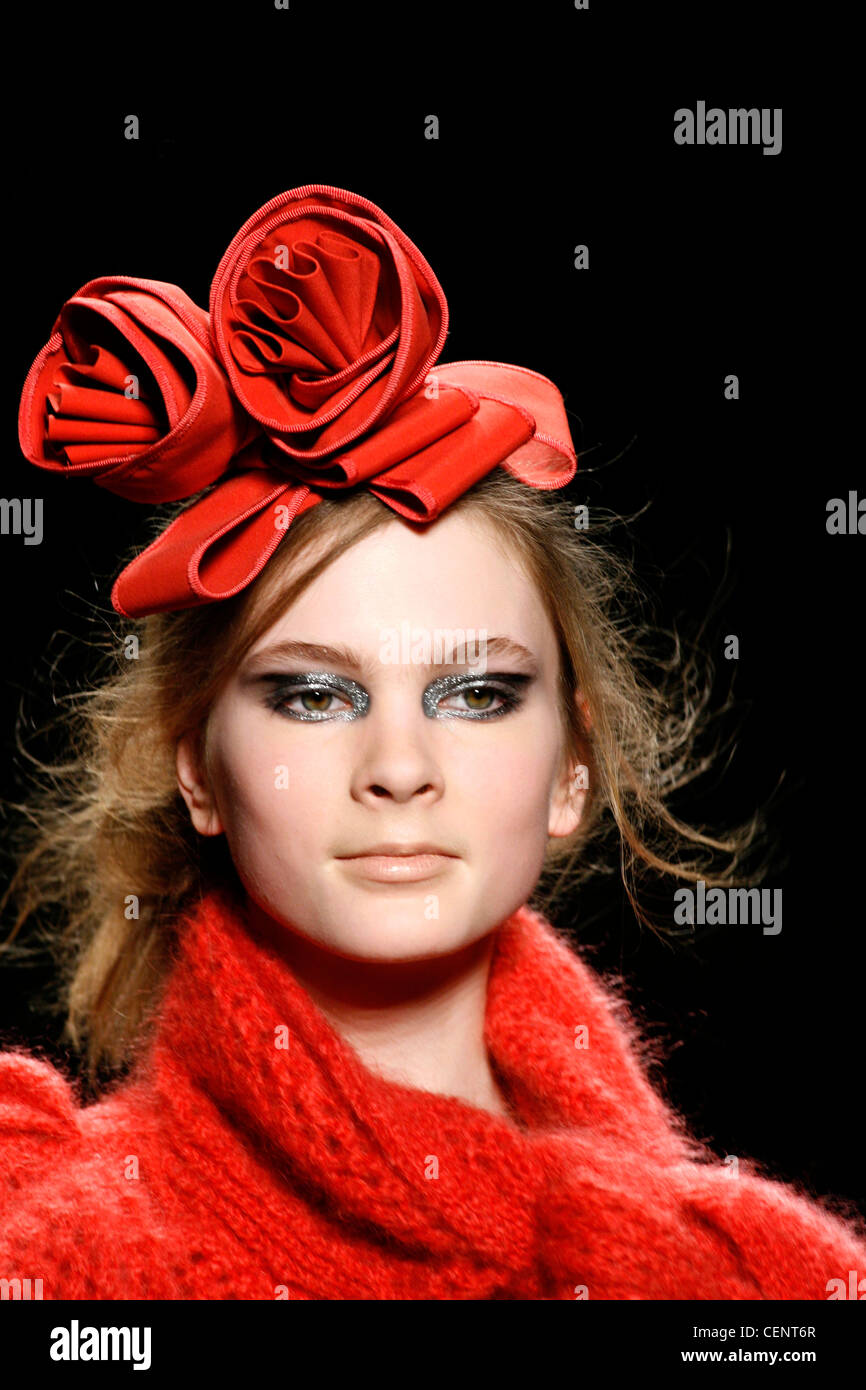 Head and shoulders red floral corsage headwear, metallic silver eyeshadow and pale lips Stock Photo