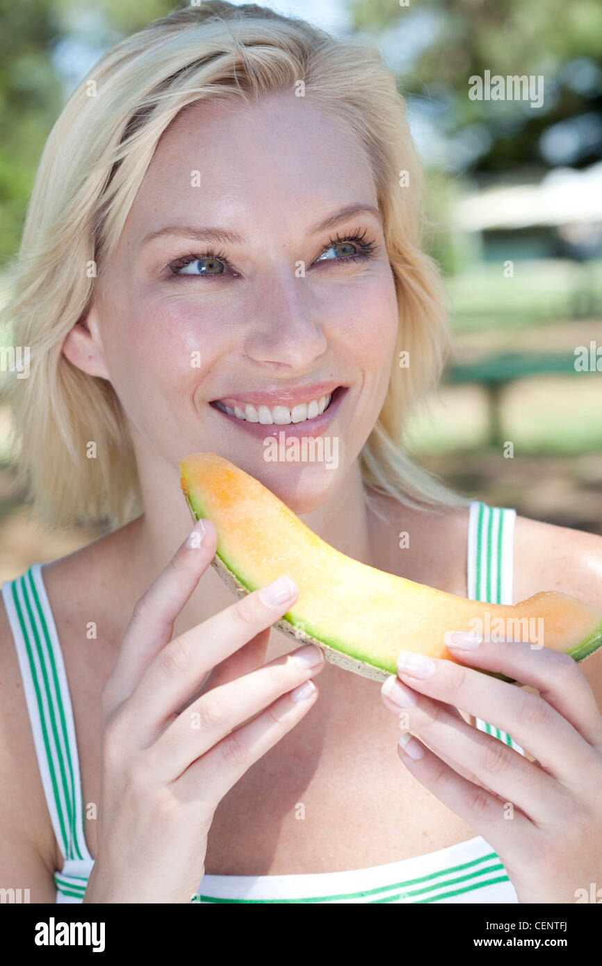 Female eating melon Stock Photo Alamy