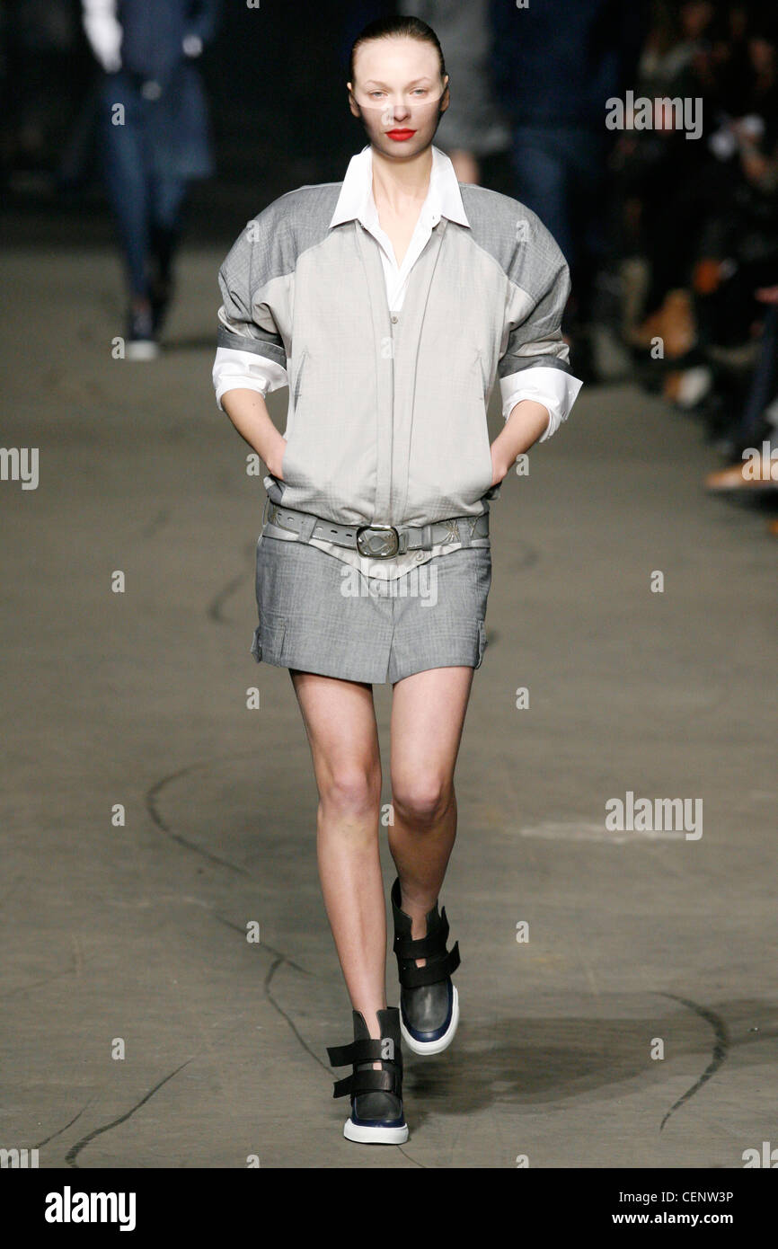 Marithe et Francois Girbaud Paris Ready to Wear Autumn Winter A model wearing a pale grey miniskirt, a pale and darker grey zip Stock Photo