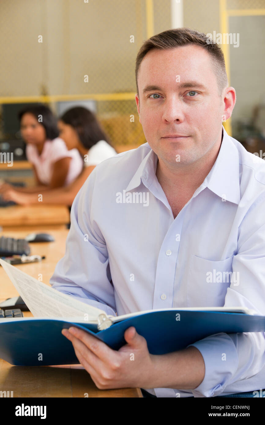 Engineering professor reading a book in a lab Stock Photo