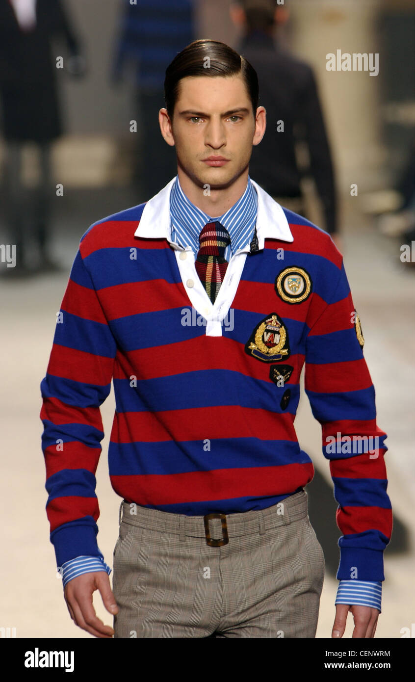 Brunette male model wearing a red and blue striped polo shirt patches, over  a blue and white striped button down shirt, plaid Stock Photo - Alamy