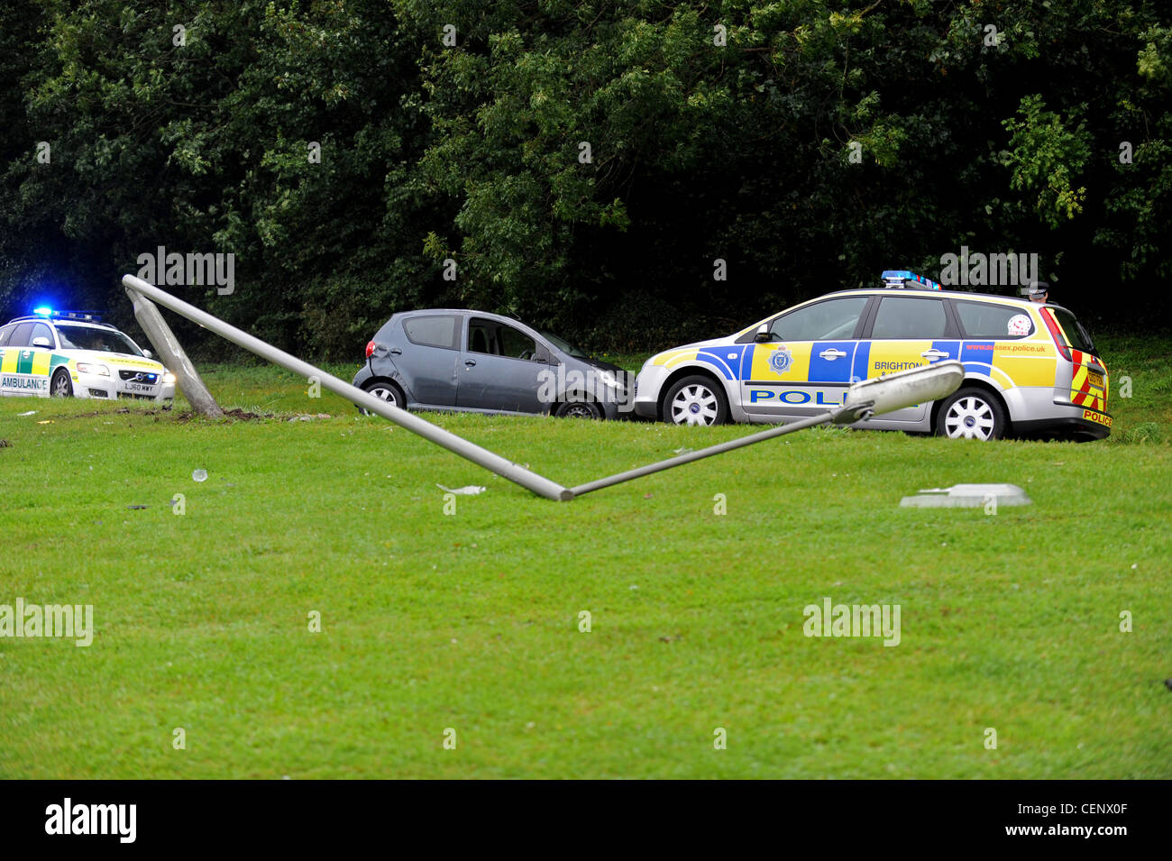 Police and ambulance at the scene of an accident where a car has collided with a lamp post Stock Photo