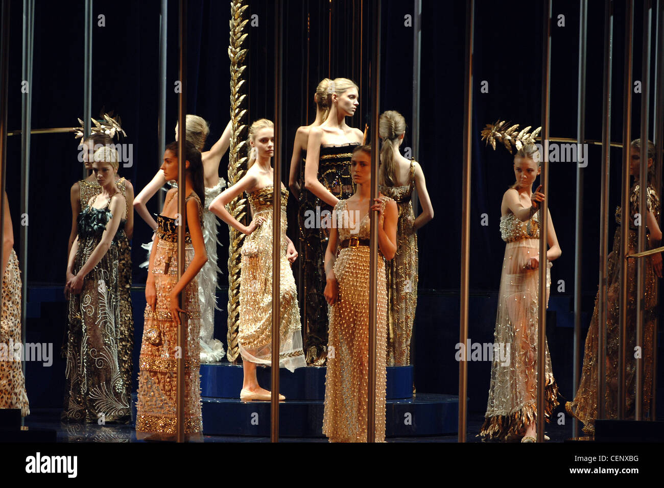 Dolce and Gabbana Ready to Wear Milan A W A group of models standing on a plinth leaning against bars, wearing long beaded Stock Photo - Alamy Dolce and Gabbana Ready to Wear Milan A W A group of models standing on a plinth leaning against bars, wearing long beaded Stock Photo - Alamy