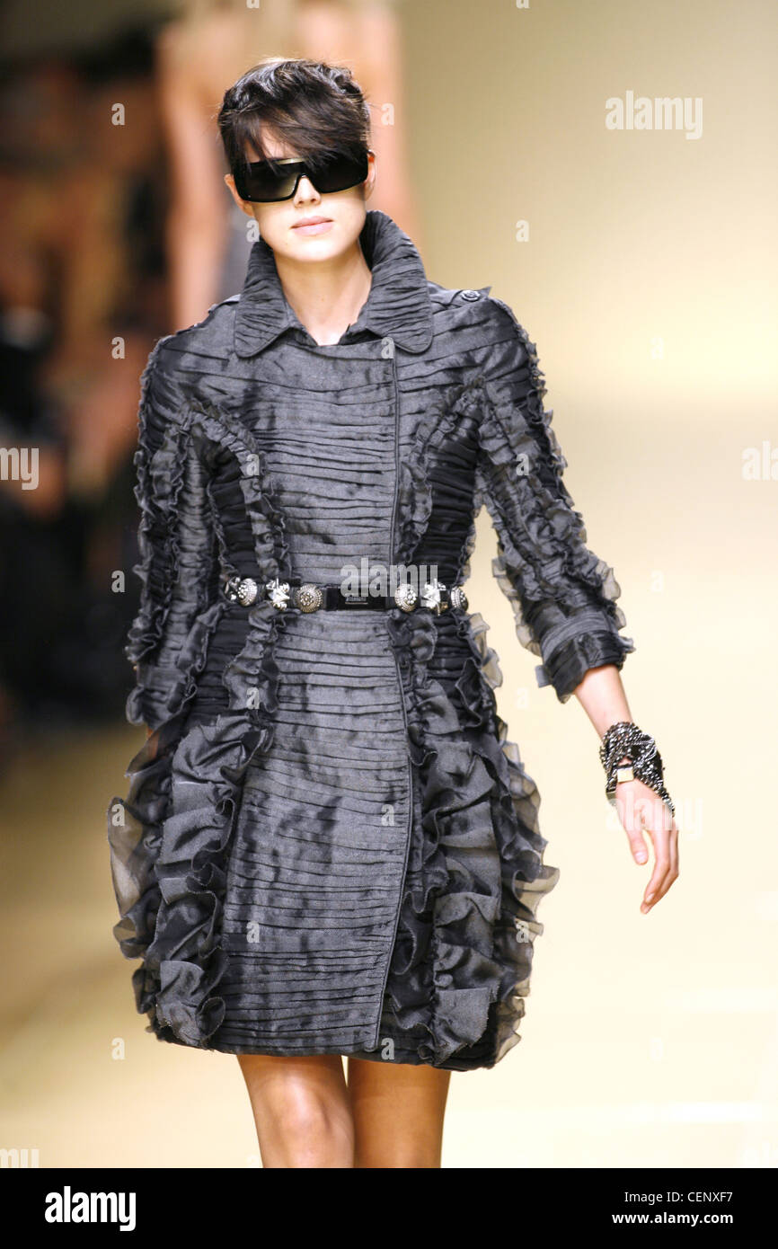 Model Agyness Deyn with short black hair, sunglasses wearing gun metal grey dress coat with belt and bracelet Stock Photo - Alamy Model Agyness Deyn with short black hair, sunglasses wearing gun metal grey dress coat with belt and bracelet Stock Photo - Alamy