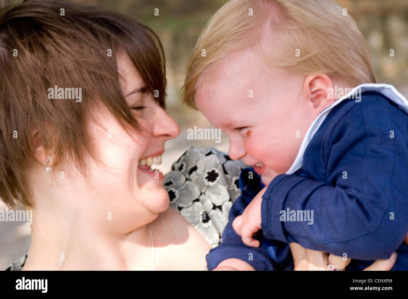 Mother holding child and smiling at each other Stock Photo - Alamy