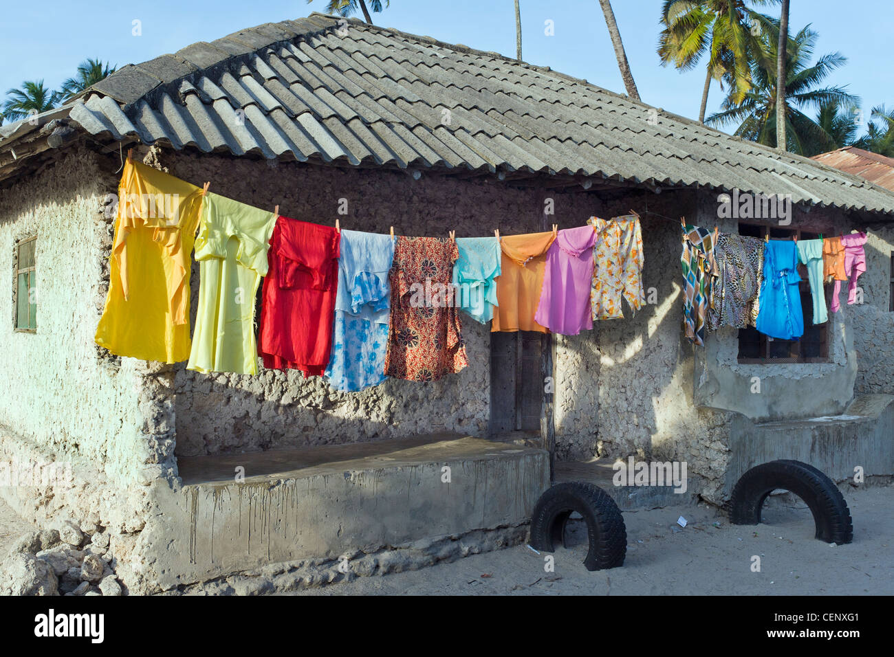 Laundry hanging on a clothesline in front a house in Bwejuu village