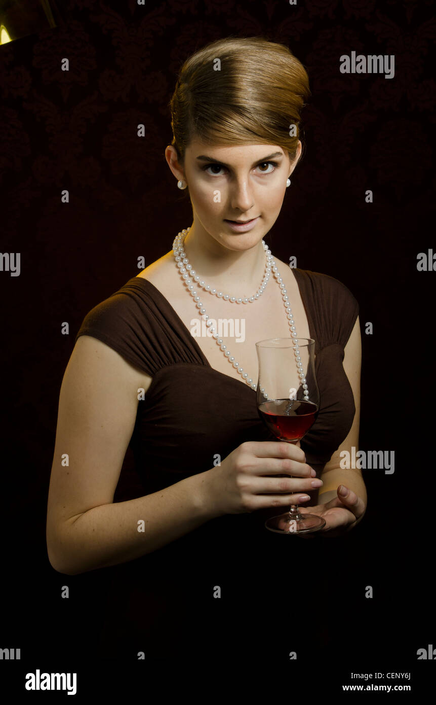 Young woman with a glas filled with red wine in her hand Stock Photo ...