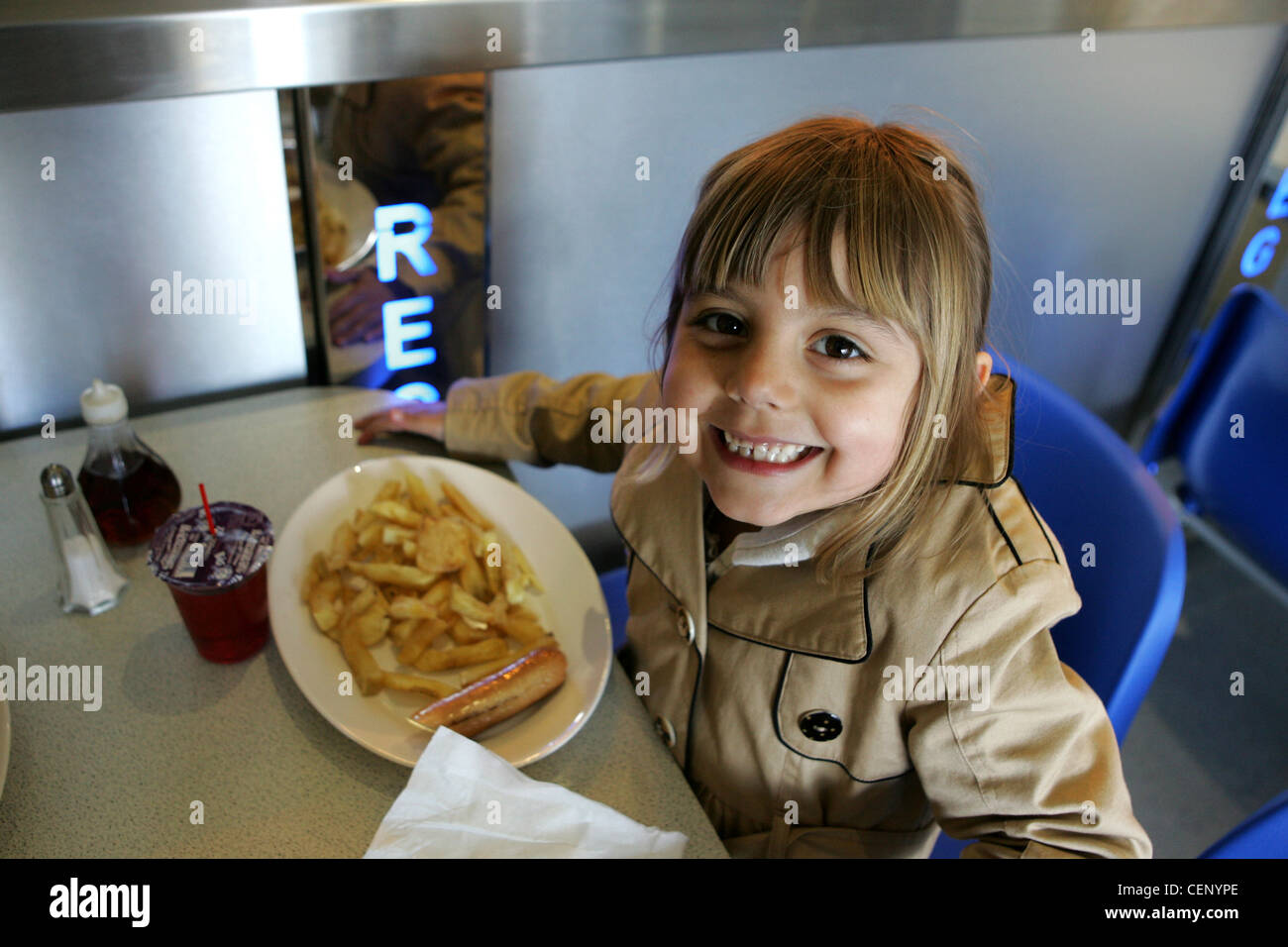 Child eating chips at chip shop in stockport Stock Photo