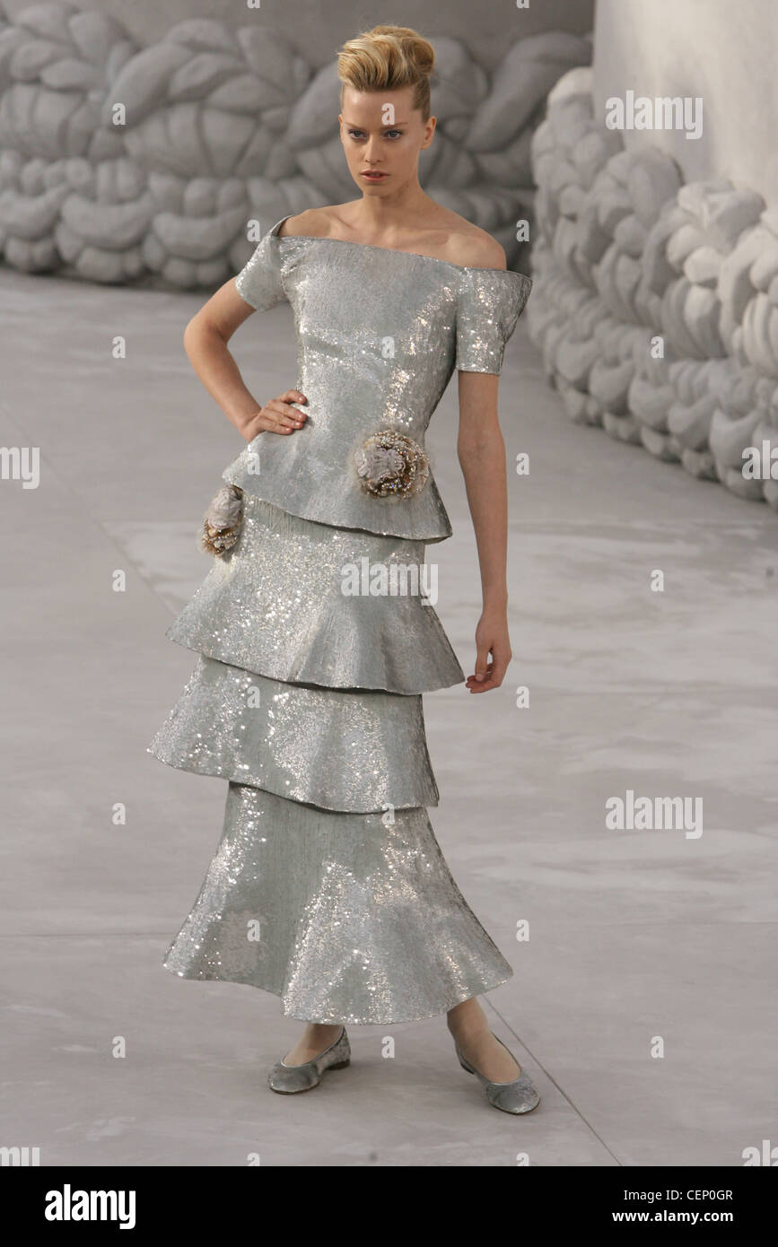 Chanel Paris Haute Couture Spring Summer Female quiff hair, wearing  metallic grey sequinned multi tiered long skirt suit Stock Photo - Alamy