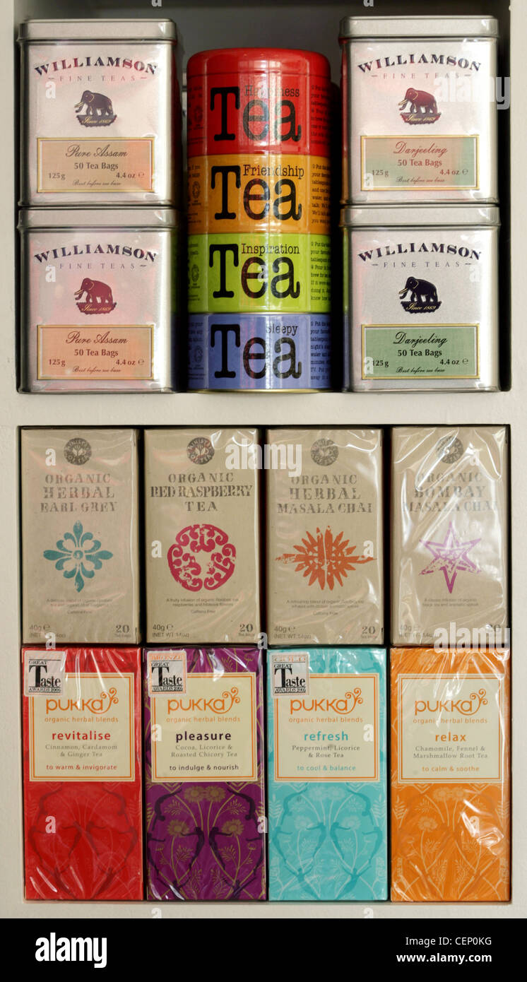 A selection of tins of different varieties of teas, with a selection of herbal teas on a shop's shelf Stock Photo
