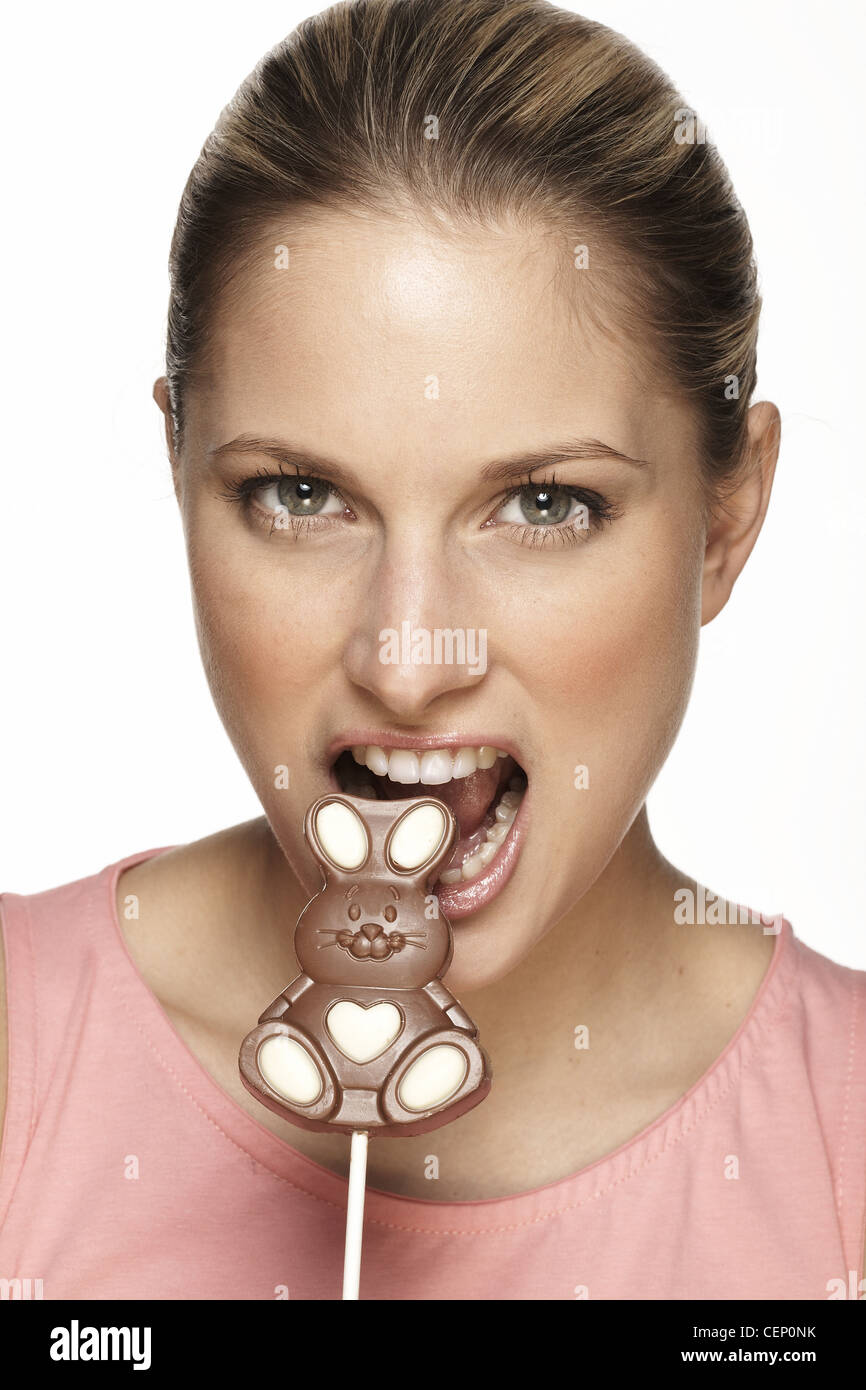 Female eating bunny shaped chocolate lolly Stock Photo Alamy