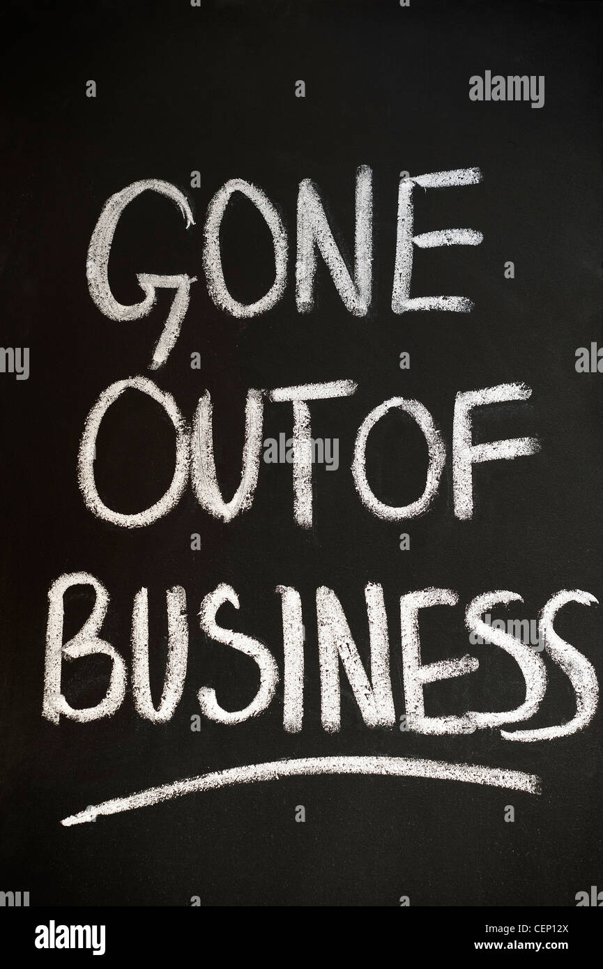 Blackboard with GONE OUT OF BUSINESS written on it in white chalk Stock Photo