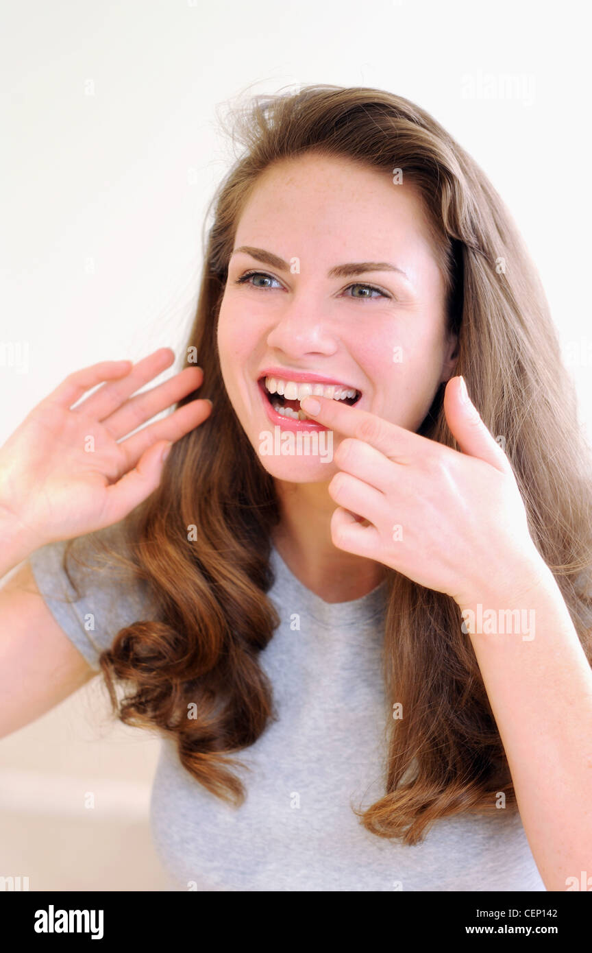 Female rubbing tooth with finger Stock Photo Alamy