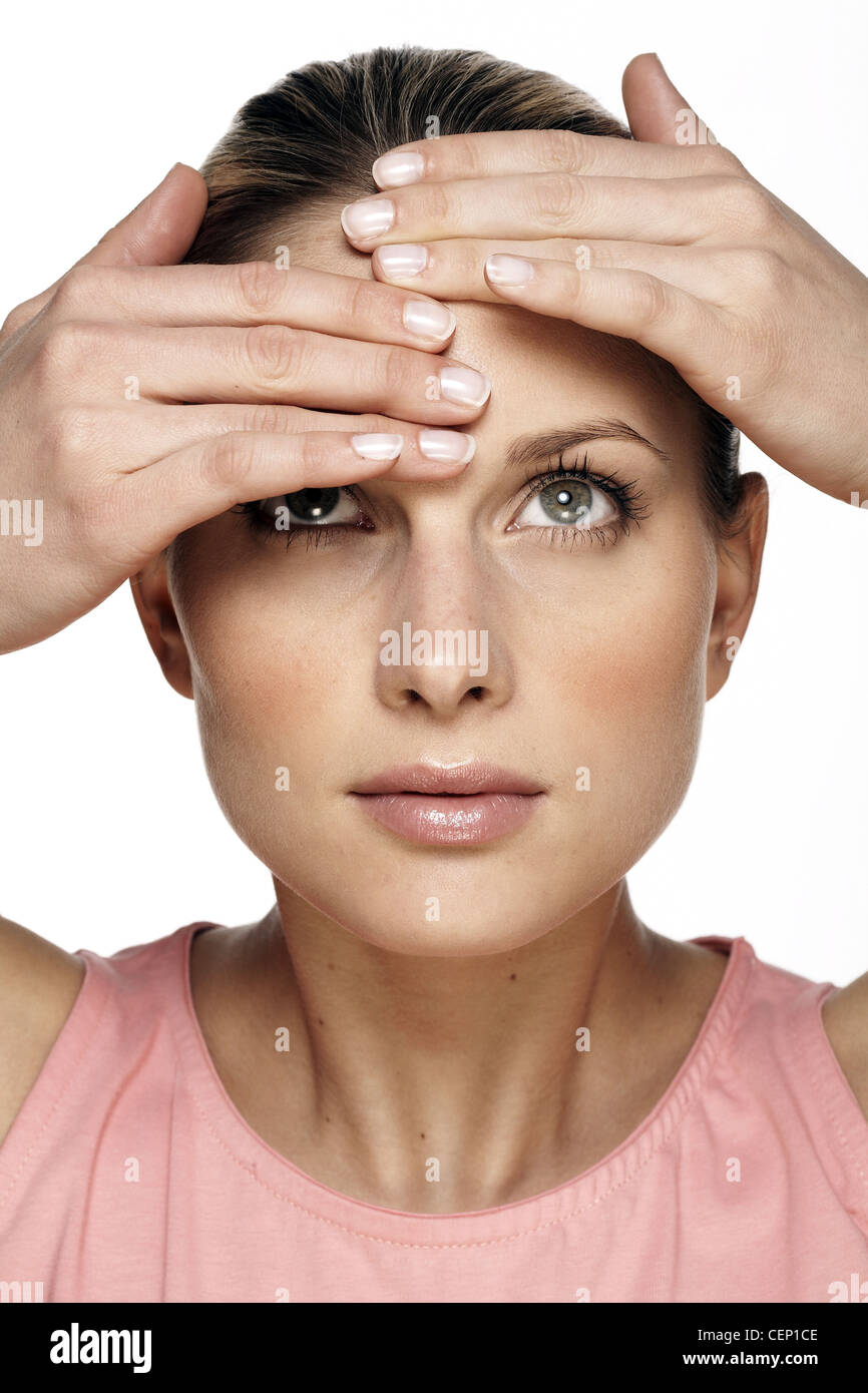 Female rubbing forehead with fingertips Stock Photo Alamy