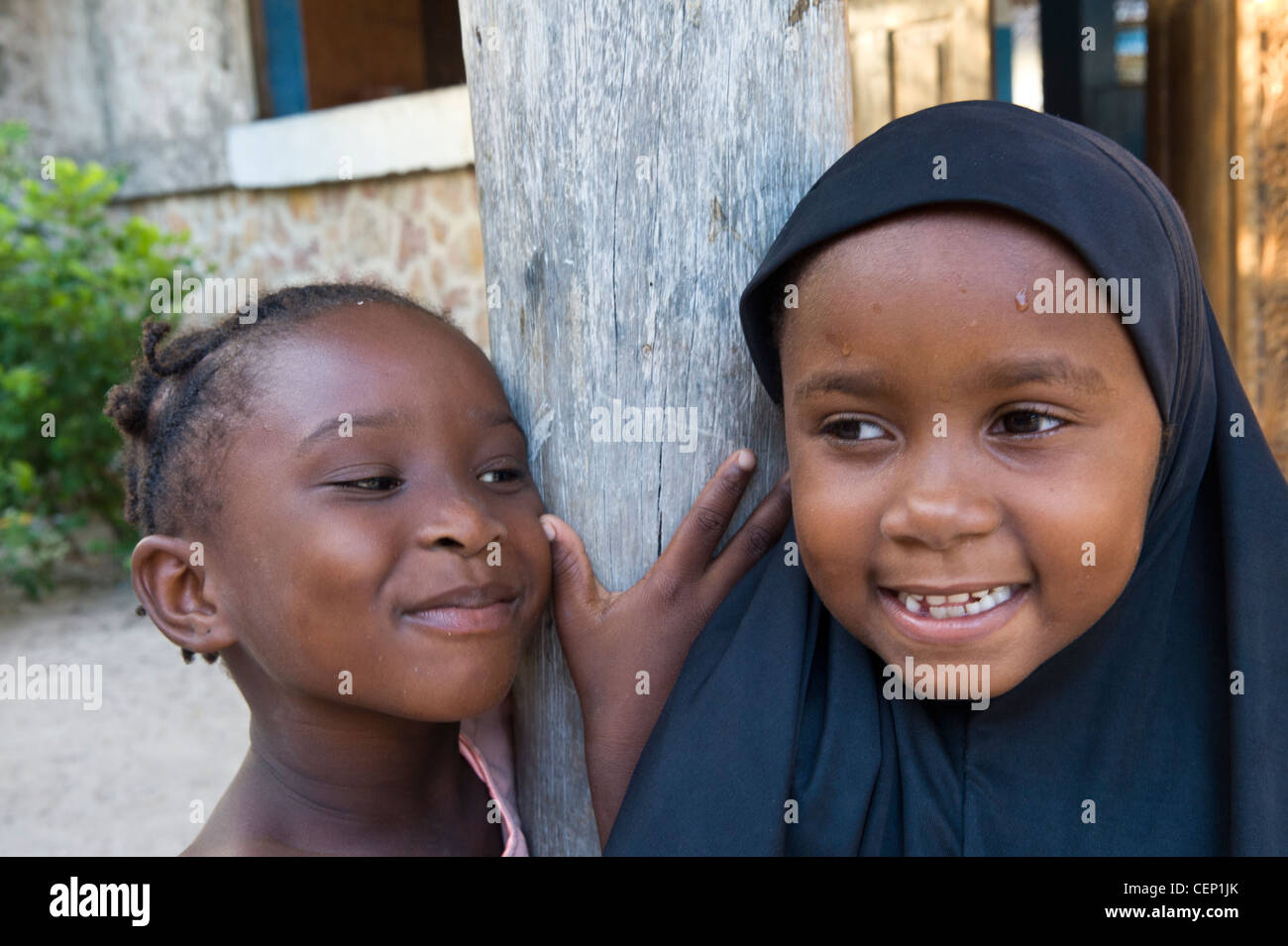 Muslim girl with a friend from Bwejuu village east coast of Zanzibar Tanzania Stock Photo